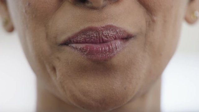 close up woman mouth smiling happy wearing glossy lipstick healthy teeth feminine beauty