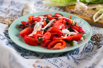 Vegetables salad with tomatoes, wakame seaweed, onion, herbs and spices. Vegan lunch, vegetarian dinner, healthy food.