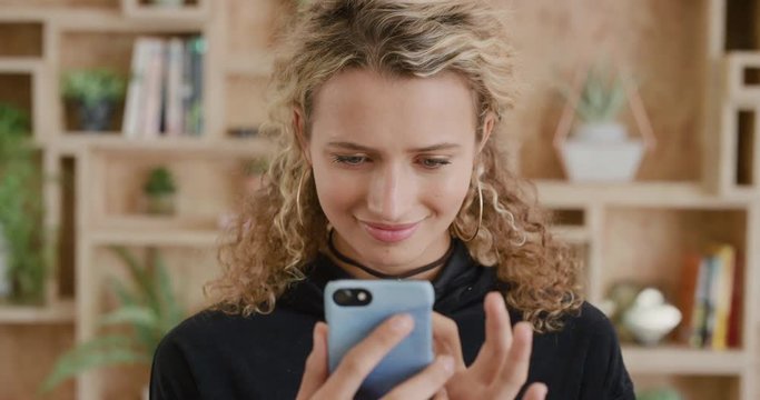 portrait of young blonde woman student using smartphone beautiful girl texting browsing online social media enjoying mobile communication real people series