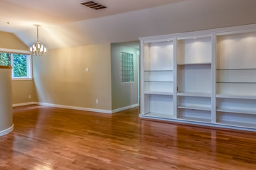 empty contemporary formal dining room with built in display shelves