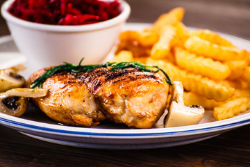 Grilled chicken fillet with french fries and vegetables