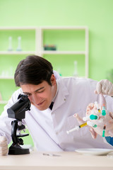 Lab assistant testing GMO chicken
