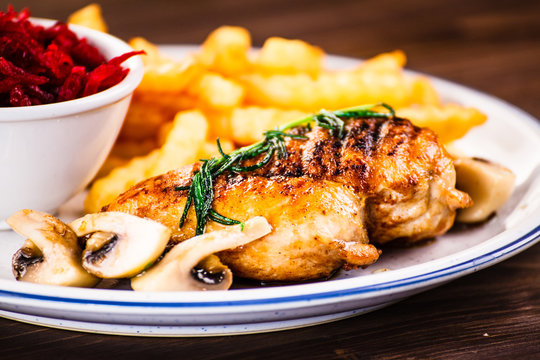 Grilled chicken fillet with french fries and vegetables