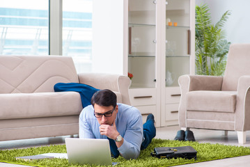 Businessman taking work home and working overtime