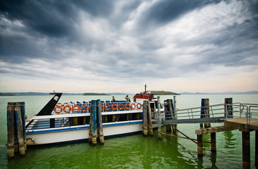 Fototapeta premium Two people boarding in Lago Trasimeno, province of Perugia, Umbria, Italy, Europe