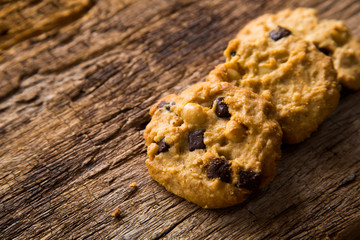 Chocolate chip cookies on rustic wood background.  Sweet biscuits. Homemade pastry