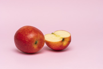 Red whole apples isolated on pink background