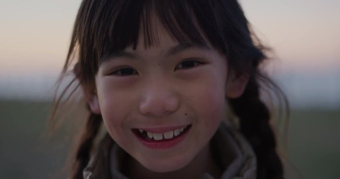 close up portrait of cute asian girl smiling cheerful enjoying happy summer vacation on seaside park
