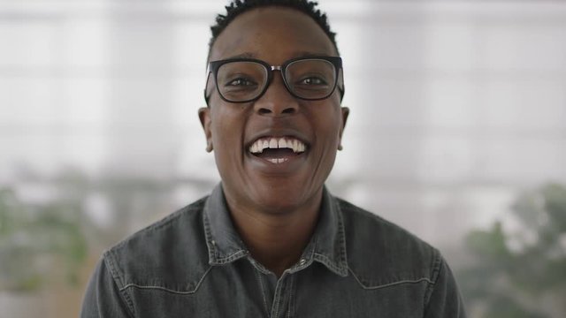 portrait of young african american business student intern man laughing cheerful at camera enjoying corporate lifestyle black guy wearing glasses