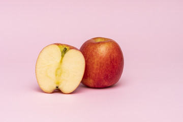 Red whole apples isolated on pink background