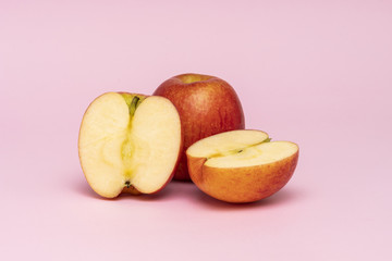 Red whole apples isolated on pink background