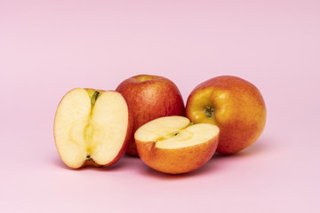Red whole apples isolated on pink background