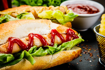 Hot dogs and french fries on cutting board