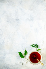Cup of tea with fresh green tea leaves