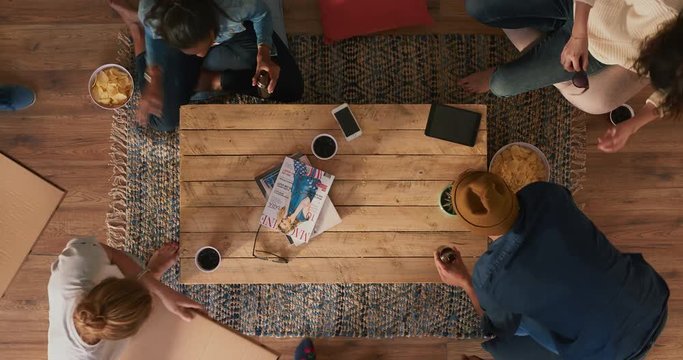 time lapse of multi ethnic friends eating pizza enjoying meal conversation sitting at table in living room time lapse above view
