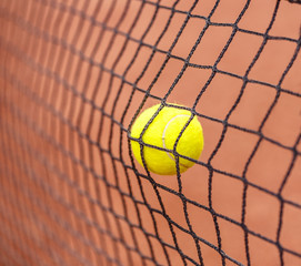 Tennis ball hitting to net