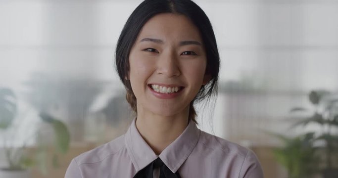 portrait young asian business woman intern laughing cheerful enjoying professional career beautiful ethnic female in office slow motion