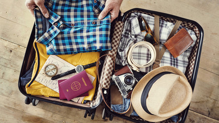 Preparing travel suitcase high angle view