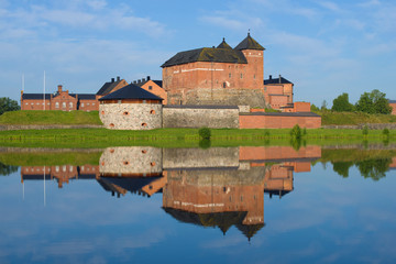 Naklejka na ściany i meble The fortress of the city of Hameenlinna with a reflection on a sunny July morning. Finland
