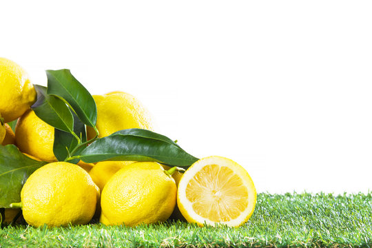 Lemon with leaves isolated on white background.
