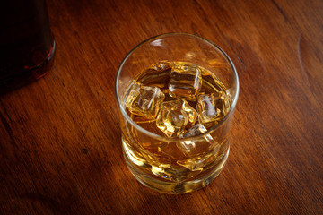Bourbon whiskey on whiskey glass with rustic and dark theme