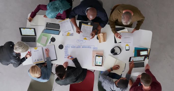 top view young diverse team of web developers brainstorming ideas for startup business website planning design layout in modern office workspace time lapse rotate