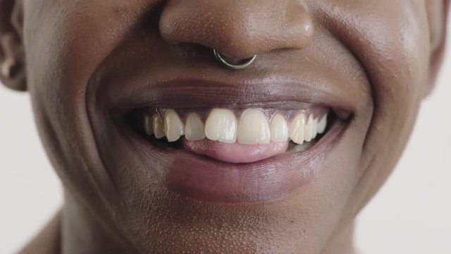 close up of african american woman mouth smiling happy showing healthy teeth oral health