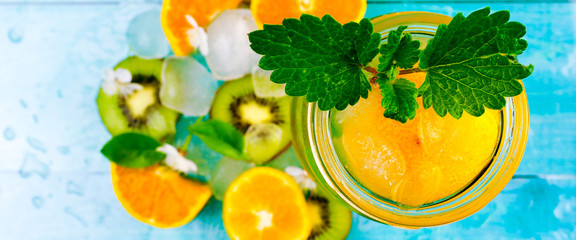 banner for website, Water with Mandarin, mint and little flowers on wooden background. Selective focus