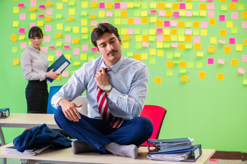 Man and woman in the office with many conflicting priorities in 