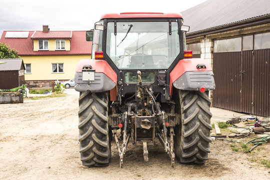 Tractor with hydraulic lift for carrying bales of hay and silage.Photo of a back view of an agricultural machine.The equipment for a dairy farm.