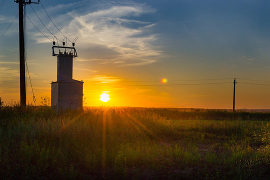 old electric shield, high voltage switch in the field at sunset