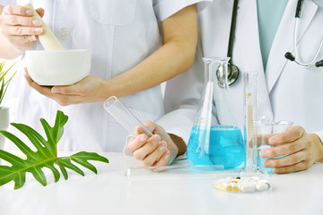 Obraz na płótnie Canvas Modern and traditional medical, Alternative organic herbal drug and chemical medicine, Doctor mixing extraction for new pharmacy formulation, Various treatment healthcare.