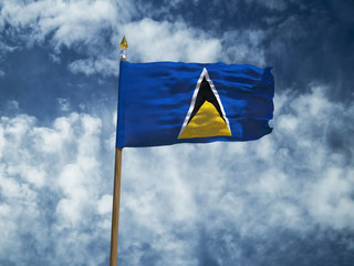 Saint Lucia flag Silk waving flag of Saint Lucia made transparent fabric with wooden flagpole gold spear on background blue sky white smoke clouds real retro photo Countries of world 3d illustration