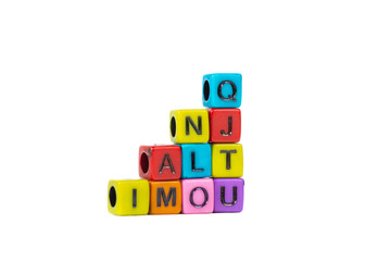 Pile of letter bead or beads with alphabet on white background.