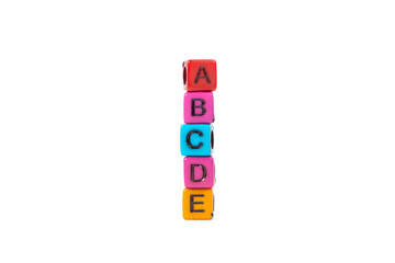 Pile of letter bead or beads with alphabet ABCDE on white background.