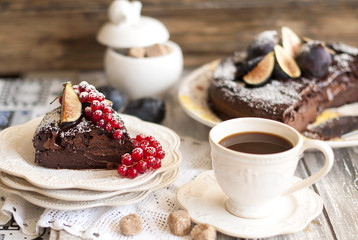chocolate cake with berries and coffee, decor of red currants and figs. Autumn fruits and pastries for breakfast