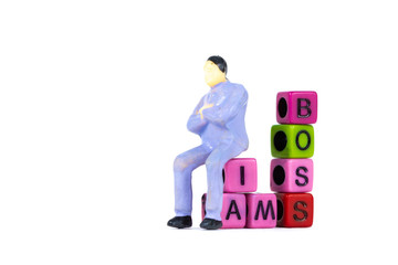 Businessman or manager or boss sitting on BOSS text made from colorful beads or letter bead on...
