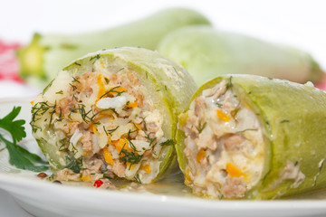 Stuffed zucchini with rice, minced meat and vegetables on white plate. Closeup image, homemade healthy cuisine.