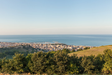 Fototapeta na wymiar Panoramic view of San Benedetto del Tronto city in the sunset light. Holiday city situated on the Adriatic sea coast, Italy