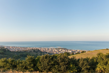 Fototapeta na wymiar Panoramic view of San Benedetto del Tronto city in the sunset light. Holiday city situated on the Adriatic sea coast, Italy