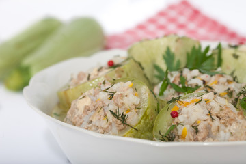 Stuffed zucchini with rice, minced meat and vegetables in white bowl. Closeup image, homemade healthy cuisine.