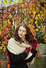 woman in a  coat walks in autumn park