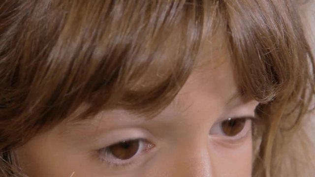 The eyes of a cute little girl wandering in the room, close-up shot.

