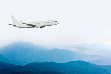 Fototapeta na wymiar airplane flying above blue mountain