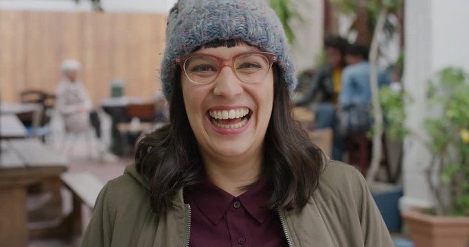 portrait of happy hipster woman wearing funky glasses laughing cheerful looking at camera