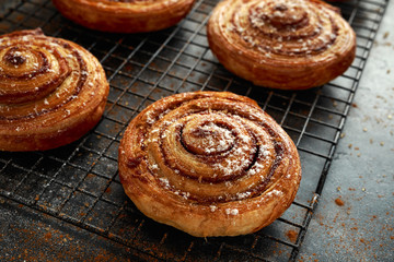 Freshly baked cinnamon swirls with icing sugar