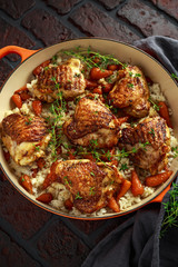 Free range chicken thighs with rice and honey glazed chantenay carrots in pan