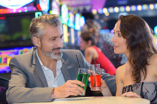 couple celebrating in casino with coktails