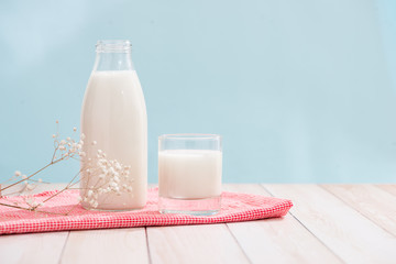 Dairy products. Bottle with milk and glass of milk on wooden table