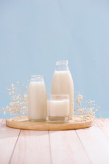 Dairy products. Bottle with milk and glass of milk on wooden table